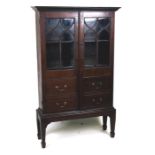 A late Victorian bookcase on stand, the pair of glazed doors with false drawer above false drawer