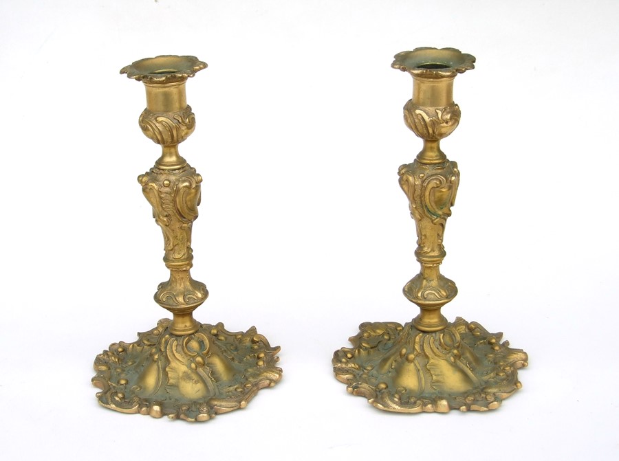 A pair of Rococo style gilt candlesticks, 23cms (9ins) high (2).