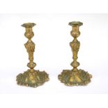 A pair of Rococo style gilt candlesticks, 23cms (9ins) high (2).