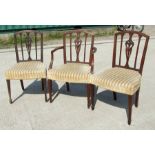A pair of mahogany chairs with over stuffed seats on square tapering legs with spade feet;