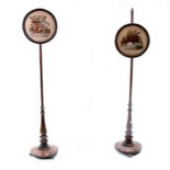 A pair of 19th century rosewood pole screens with circular needlework panels depicting birds and