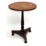 A William IV rosewood games table on turned column and trefoil base, 54cms (21.25ins) diameter.