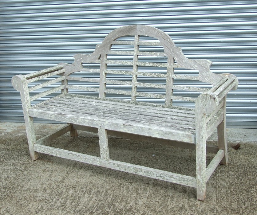 A well weathered teak Lutyen style garden bench, 170cms (67ins) wide.