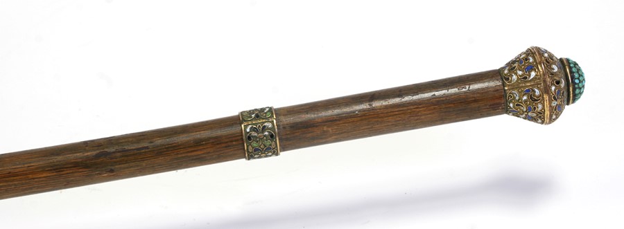 A turquoise set gilt metal and enamel handled walking cane, 93cms (36.5ins) long.