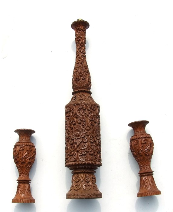 An Indian carved hardwood table lamp, 77cms (30.5ins) high; together with two similar vases,