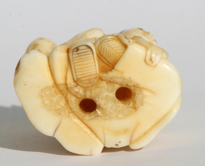 A 19th century Japanese carved ivory netsuke in the form of a boy holding a calligraphy brush, 3. - Image 2 of 3