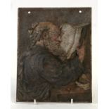 A cold painted cast iron plaque depicting a monk reading a manuscript, 16 by 21cms (6.25 by 8.