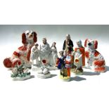A group of Staffordshire pottery figures to include spaniels and spill vases, the largest 31cms (