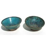 Two Chinese green glazed pottery footed bowls, possibly Han Dynasty, 12cms (4.75ins) diameter (2).