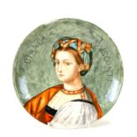 An Art pottery plate decorated with a Renaissance figure 'Bianca Visconti' and monogrammed, 22cms (