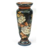 A Doulton Lambeth faience vase decorated with flowers, impressed mark and potter's mark possibly for