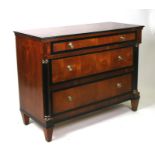 A Biedermeier style chest of three graduated long drawers flanked by ebonised pillars, 106cms (41.