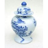 A Chinese blue & white temple jar and cover decorated with flowering foliage, 33cms (13ins) high.