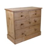 A stripped pine bedroom chest with two short and two graduated long drawers, 92cms (36ins) wide.