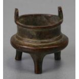 A Chinese miniature bronze two-handled censer on three legs, four character mark to the underside,