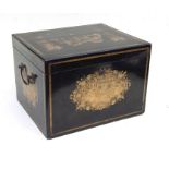 A 19th century Chinese Export black lacquer tea caddy decorated with gilded panels depicting figures