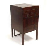 A Georgian mahogany gentleman's washstand, the folding top enclosing a fitted interior and a rise-