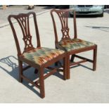 A pair of Georgian mahogany chairs with drop-in upholstered seats, on chamfered square front