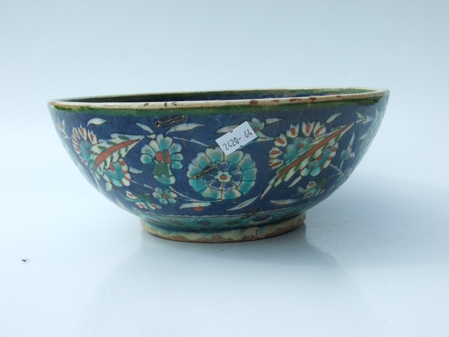 An Iznik pottery bowl decorated with flowers on a green ground, 27cms (10.5ins) diameter; together - Image 15 of 17