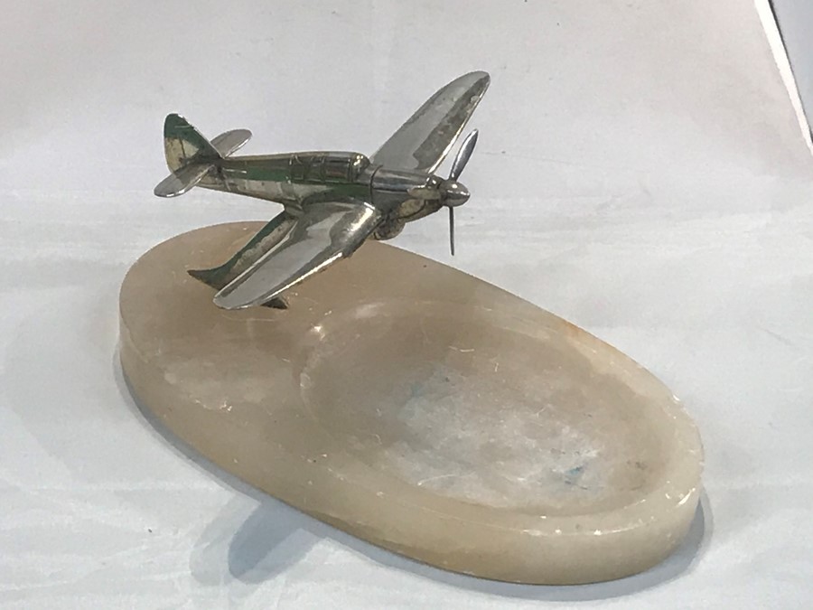 A mid century desk stand, surmounted a silver plated Spitfire on the alabaster base, 18 cm, 7 inch