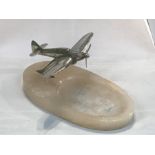 A mid century desk stand, surmounted a silver plated Spitfire on the alabaster base, 18 cm, 7 inch