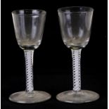 A near pair of 18th century wine glasses with air twist stems, 13cms (5ins) high (2).Condition