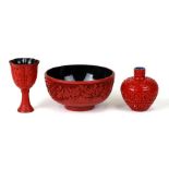 A Chinese cinnabar lacquer footed bowl, 12.5cms (5ins) diameter; together with two similar vases (