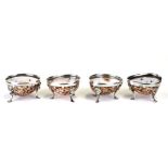 A set of four 18th century un-hallmarked silver leopard cowrie shell salts with lion mask capped