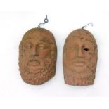 A pair of terracotta Grecian style wall masks in the form of bearded men, 22cms (8.75ins) high) (
