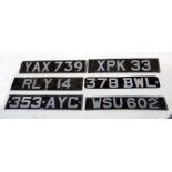 Seven pressed aluminium number plates with various registration numbers, for display purposes