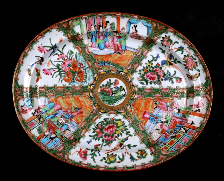 A 19th century Chinese famille rose oval meat plate decorated with figures, flowers, butterflies and