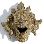 A Tibetan bronze mask incense burner, 11cm (4.25ins) long.