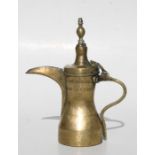 A Turkish / Islamic brass dallah coffee pot, 25cms (9.75ins) high.