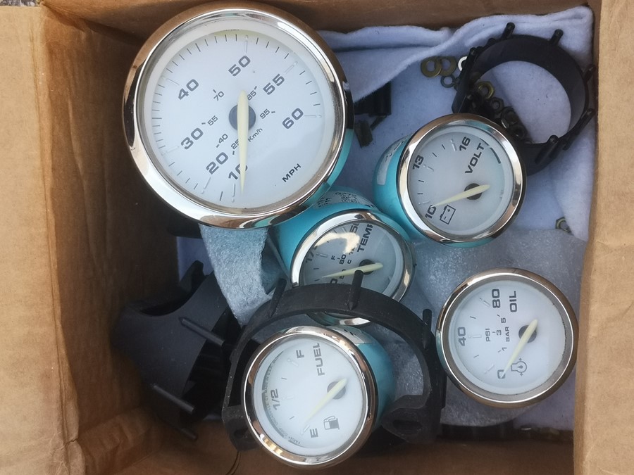 A set of Faria Corp dashboard gauges - miles per hour, fuel, oil pressure, volts, water temperature,