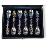 A set of six cased cast white metal spoons, weight 132g.