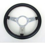 A leather rimmed aluminium three-spoke dished steering wheel, 36cms (14ins) diameter.