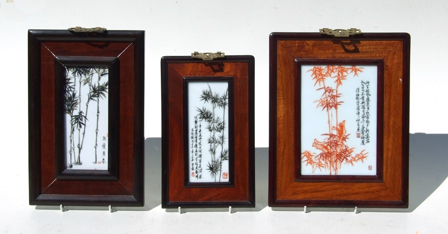 Three Chinese Republic style porcelain panels depicting bamboo and calligraphy, framed, the