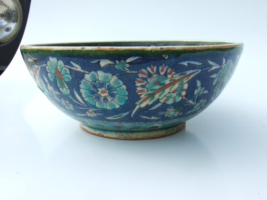 An Iznik pottery bowl decorated with flowers on a green ground, 27cms (10.5ins) diameter; together - Image 3 of 17
