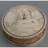 A 19th century ivory pin cushion carved in relief with a courting couple under a tree, 5cms (2ins)