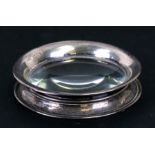 An Asprey silver mounted desk magnifier, 8.5cms (3.75ins) diameter.Condition Reportsome minor