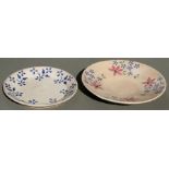 Two Studio Pottery dishes decorated with flowers, signed 'J Ana (?), the largest 32cms (12.5ins)
