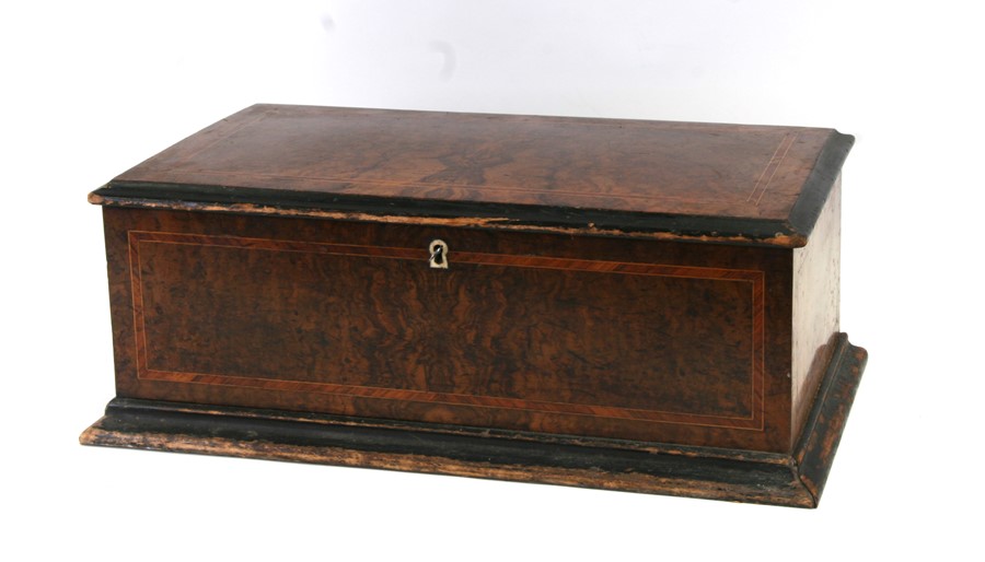 A 19th century music box with seven bells within a walnut case, 50cms (19.5ins) wide.Condition