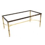A brass coffee table base on reeded supports joined by a stretcher, 99cms (39ins) wide.Condition