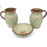 Two 1950's Denby Ferndale tube lined jugs, 30cms (12ins) high; together with a matching bowl,