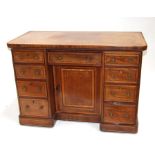 A 19th century mahogany kneehole desk, the rectangular crossbanded top above an arrangement of