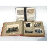 Approximately 200 early to mid 20th century Military postcards and photographs contained in a red