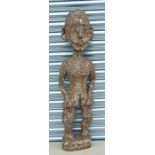 A large African carved wooden figure in the form of a standing female, approx 94cms high; together