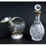 A silver mounted decanter; together with an Italian Marinoni pewter mounted wine carafe (2).