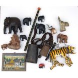 A quantity of tribal and Indian items to include a large cow bell, a carved wooden elephant and a