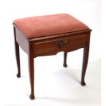 An Edwardian walnut piano stool, 49cms wide.